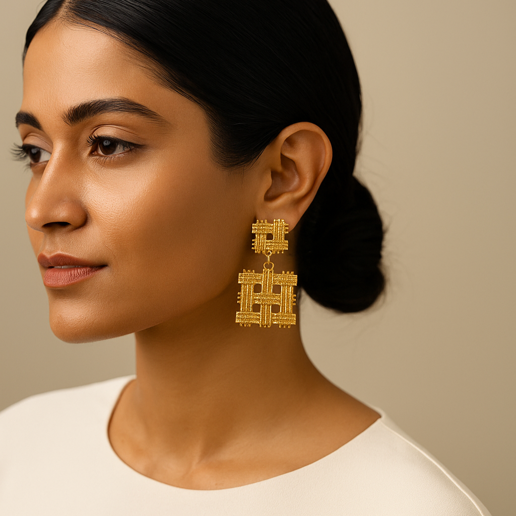 Woman wearing gold earrings with a neutral background